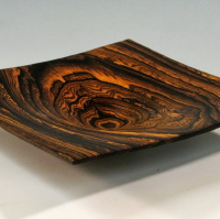 A wooden bowl with a pattern of wood grain.