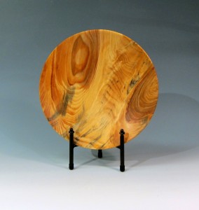 A wooden plate with a stand on it