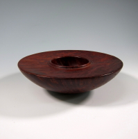 A wooden bowl sitting on top of a table.